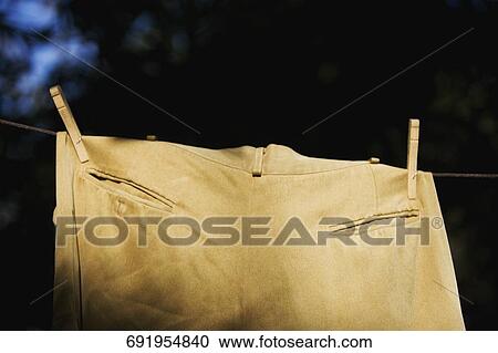 Pants hanging on a clothesline View Large Photo Image Stock Image - Pants hanging on a clothesline. Fotosearch