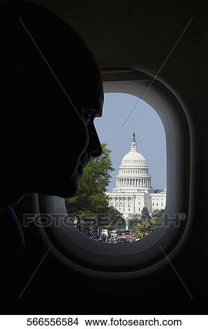 Passenger looking at a building through the window of an airplane, Capitol Building, Washington DC, USA View Large Photo Image Picture - Passenger looking at a building through the window of an airplane, Capitol Building, Washington DC, USA. Fotosearch