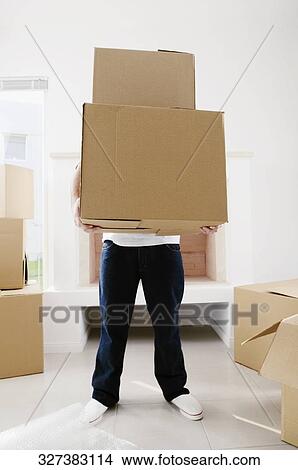Person carrying cardboard boxes View Large Photo Image Picture - Person carrying cardboard boxes. Fotosearch