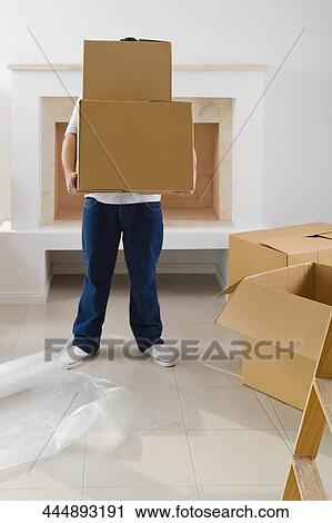 Person carrying cardboard boxes View Large Photo Image Stock Image - Person carrying cardboard boxes. Fotosearch