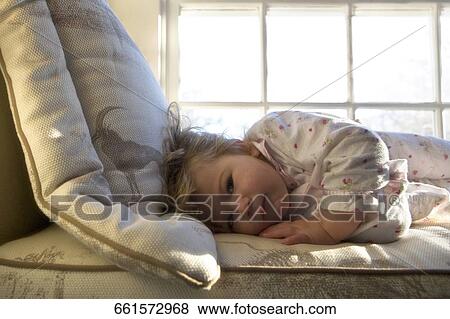 Portrait of a baby girl lying on the bed View Large Photo Image Stock Photo - Portrait of a baby girl lying on the bed. Fotosearch