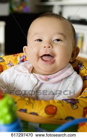 Portrait of a baby girl sitting in a toy swing and smiling View Large Photo Image Stock Image - Portrait of a baby girl sitting in a toy swing and smiling. Fotosearch