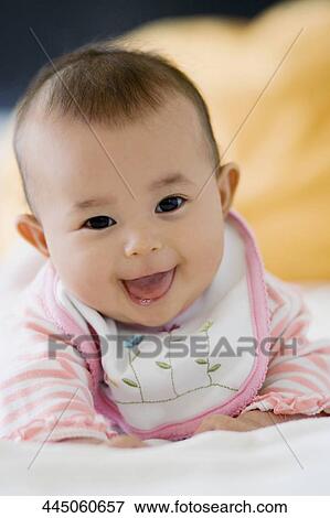 Portrait of a baby girl smiling View Large Photo Image Stock Photo - Portrait of a baby girl smiling. Fotosearch