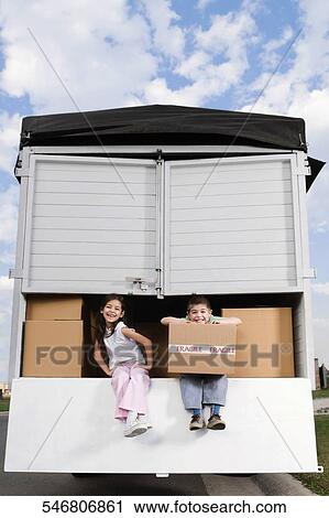 Portrait of a boy and a girl sitting in a truck and smiling View Large Photo Image Stock Image - Portrait of a boy and a girl sitting in a truck and smiling. Fotosearch