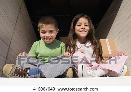 Portrait of a boy and a girl smiling View Large Photo Image Stock Photo - Portrait of a boy and a girl smiling. Fotosearch
