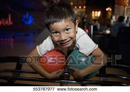 Portrait of a boy holding a bowling ball View Large Photo Image Stock Photo - Portrait of a boy holding a bowling ball. Fotosearch