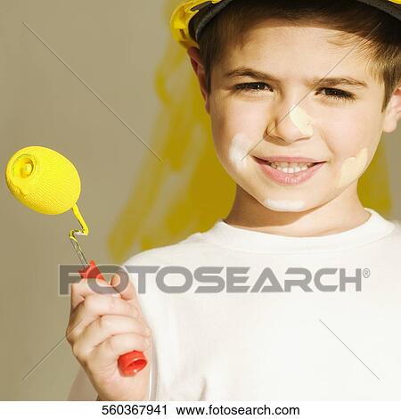 Portrait of a boy holding a paint roller and smiling View Large Photo Image Stock Image - Portrait of a boy holding a paint roller and smiling. Fotosearch