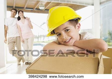 Portrait of a boy smiling with his parents standing in the background View Large Photo Image Stock Photo - Portrait of a boy smiling with his parents standing in the background. Fotosearch