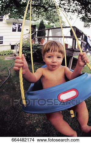 Portrait of a boy swinging on a swing View Large Photo Image Picture - Portrait of a boy swinging on a swing. Fotosearch