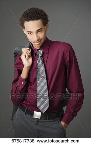 Portrait of a businessman carrying his coat over his shoulder and smiling View Large Photo Image Stock Photo - Portrait of a businessman carrying his coat over his shoulder and smiling. Fotosearch