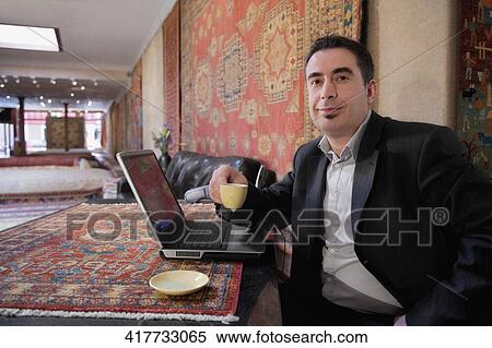 Portrait of a businessman having tea in a restaurant View Large Photo Image Stock Photography - Portrait of a businessman having tea in a restaurant. Fotosearch