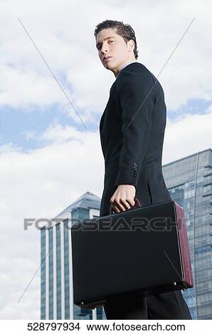Picture - Portrait of a businessman holding a briefcase. Fotosearch
