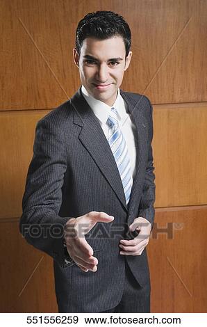 Portrait of a businessman offering for handshake and smiling View Large Photo Image Stock Photo - Portrait of a businessman offering for handshake and smiling. Fotosearch