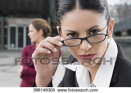 Portrait of a businesswoman holding her eyeglasses View Large Photo Image Stock Photography - Portrait of a businesswoman holding her eyeglasses. Fotosearch