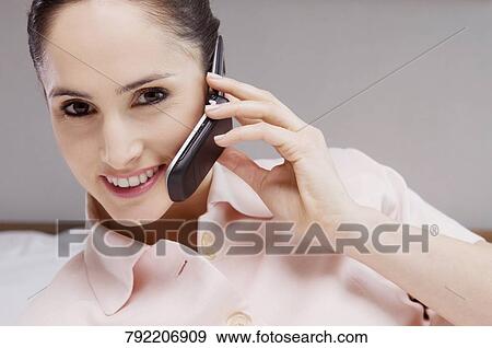 Stock Photo - Portrait of a businesswoman talking on a mobile phone. Fotosearch