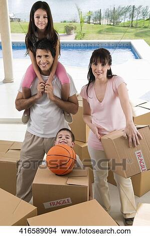 Portrait of a couple smiling with their children View Large Photo Image Picture - Portrait of a couple smiling with their children. Fotosearch