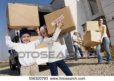 Portrait of a family loading cardboard boxes in a truck View Large Photo Image Stock Image - Portrait of a family loading cardboard boxes in a truck. Fotosearch