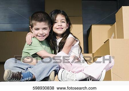 Portrait of a girl and a boy hugging each other View Large Photo Image Stock Photo - Portrait of a girl and a boy hugging each other. Fotosearch