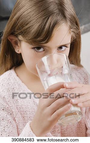 Portrait of a girl drinking a glass of milk View Large Photo Image Stock Image - Portrait of a girl drinking a glass of milk. Fotosearch