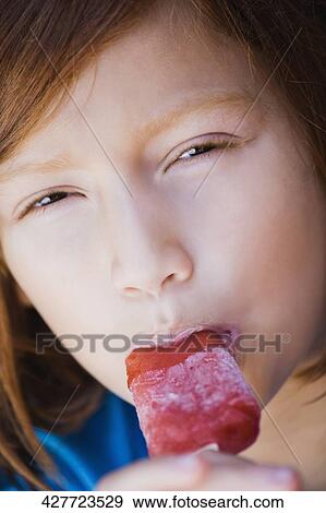 Portrait of a girl eating an ice cream View Large Photo Image Stock Photo - Portrait of a girl eating an ice cream. Fotosearch