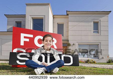 Portrait of a girl holding a sold information board and smiling View Large Photo Image Stock Photo - Portrait of a girl holding a sold information board and smiling. Fotosearch