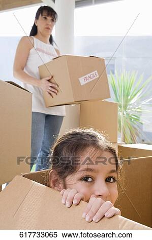 Portrait of a girl in a cardboard box and her mother standing in the background View Large Photo Image Stock Photography - Portrait of a girl in a cardboard box and her mother standing in the background. Fotosearch