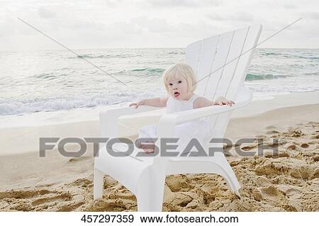 Portrait of a girl sitting on an adirondack chair and sticking her tongue out View Large Photo Image Stock Photo - Portrait of a girl sitting on an adirondack chair and sticking her tongue out. Fotosearch