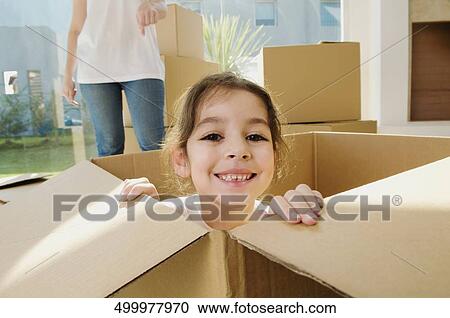 Portrait of a girl smiling in a cardboard box View Large Photo Image Stock Image - Portrait of a girl smiling in a cardboard box. Fotosearch