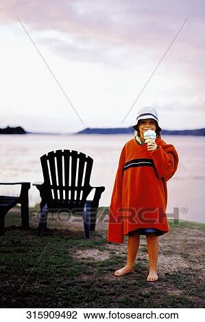 Portrait of a girl standing on the beach and holding an ice cream cone View Large Photo Image Stock Image - Portrait of a girl standing on the beach and holding an ice cream cone. Fotosearch