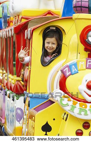 Portrait of a girl waving her hand in a train View Large Photo Image Stock Image - Portrait of a girl waving her hand in a train. Fotosearch