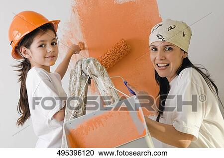 Portrait of a mature woman and her daughter painting a wall View Large Photo Image Stock Image - Portrait of a mature woman and her daughter painting a wall. Fotosearch