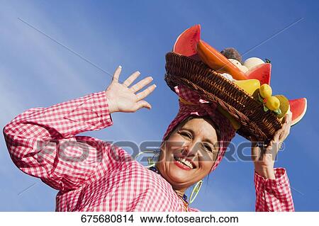 Picture - Portrait of a mature woman selling fruits. Fotosearch