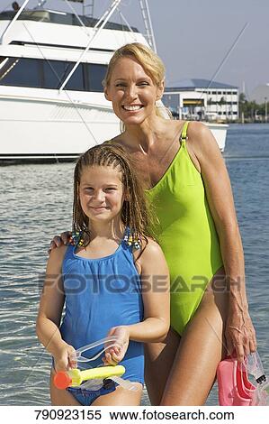 Stock Photography - Portrait of a mature woman with her daughter smiling. Fotosearch