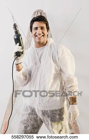 Portrait of a mid adult man holding drill machine and smiling View Large Photo Image Stock Photography - Portrait of a mid adult man holding drill machine and smiling. Fotosearch