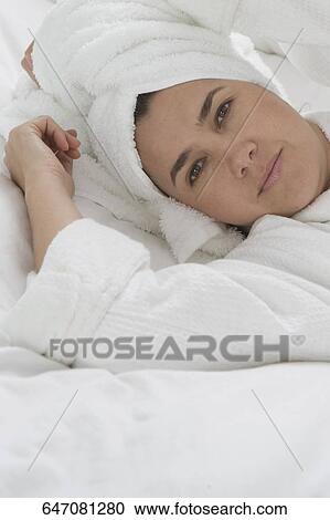 Portrait of a mid adult man lying on the bed in a bathrobe View Large Photo Image Stock Image - Portrait of a mid adult man lying on the bed in a bathrobe. Fotosearch