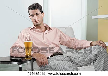 Portrait of a mid adult man with a glass of beer View Large Photo Image Stock Photo - Portrait of a mid adult man with a glass of beer. Fotosearch