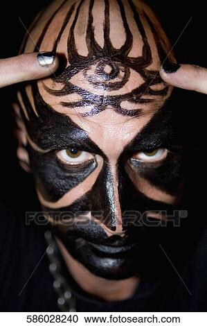 Portrait of a mid adult man with face paint on his face View Large Photo Image Stock Image - Portrait of a mid adult man with face paint on his face. Fotosearch