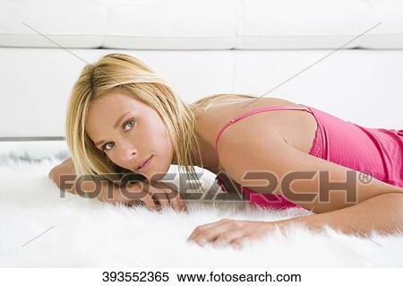 Portrait of a mid adult woman lying on rug View Large Photo Image Stock Photography - Portrait of a mid adult woman lying on rug. Fotosearch