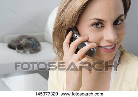 Portrait of a mid adult woman talking on a mobile phone View Large Photo Image Stock Image - Portrait of a mid adult woman talking on a mobile phone. Fotosearch