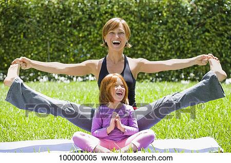 Portrait of a mid adult woman with her daughter practicing yoga View Large Photo Image Stock Photography - Portrait of a mid adult woman with her daughter practicing yoga. Fotosearch