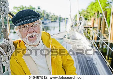 Portrait of a senior man leaning against a wooden post View Large Photo Image Stock Image - Portrait of a senior man leaning against a wooden post. Fotosearch