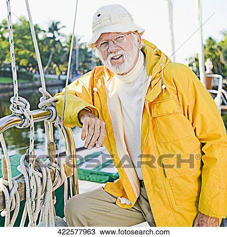 Portrait of a senior man standing on a ship and smiling View Large Photo Image Stock Image - Portrait of a senior man standing on a ship and smiling. Fotosearch