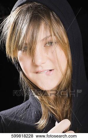 Portrait of a teenage girl biting her lips View Large Photo Image Stock Photo - Portrait of a teenage girl biting her lips. Fotosearch