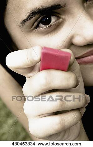 Portrait of a teenage girl holding a bubble gum View Large Photo Image Picture - Portrait of a teenage girl holding a bubble gum. Fotosearch