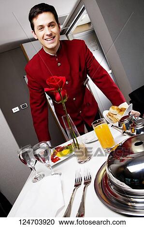 Portrait of a waiter pushing the trolley of breakfast View Large Photo Image Stock Image - Portrait of a waiter pushing the trolley of breakfast. Fotosearch