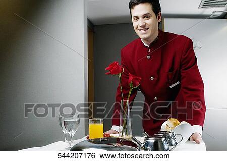 Portrait of a waiter pushing the trolley of breakfast View Large Photo Image Stock Photograph - Portrait of a waiter pushing the trolley of breakfast. Fotosearch