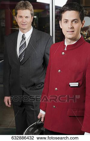 Portrait of a waiter with a businessman View Large Photo Image Stock Image - Portrait of a waiter with a businessman. Fotosearch