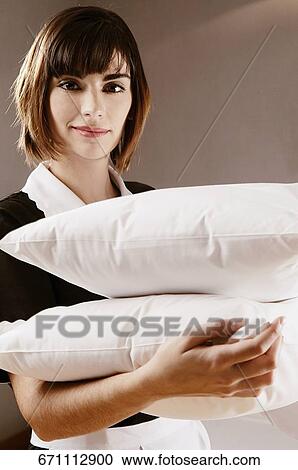 Portrait of a waitress holding pillows View Large Photo Image Stock Image - Portrait of a waitress holding pillows. Fotosearch
