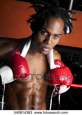 Portrait of a young male boxer holding a towel View Large Photo Image Stock Image - Portrait of a young male boxer holding a towel. Fotosearch