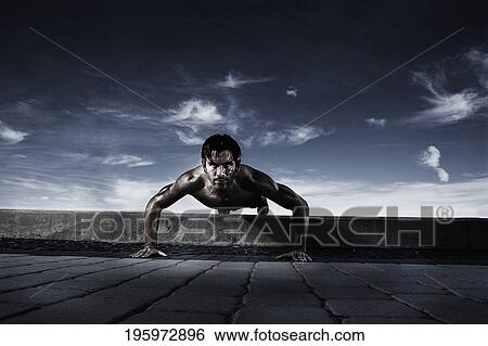 Portrait of a young man doing push-ups View Large Photo Image Stock Photograph - Portrait of a young man doing push-ups. Fotosearch